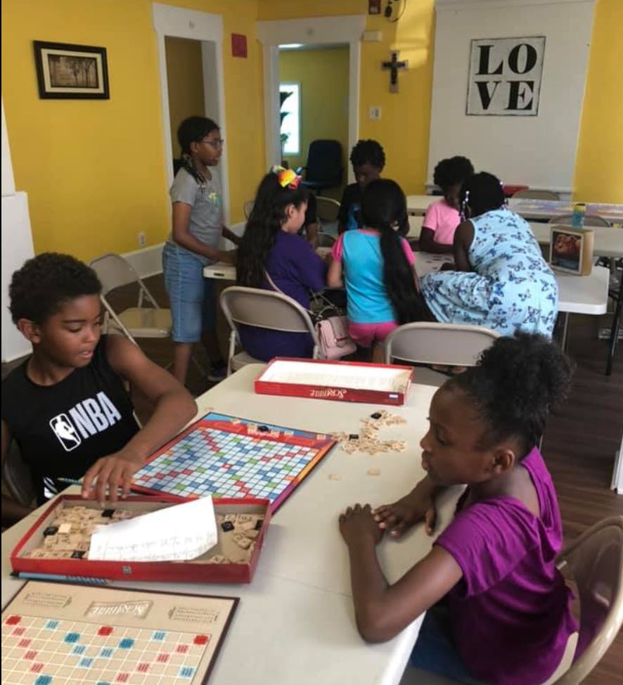 Children playing board games at tables