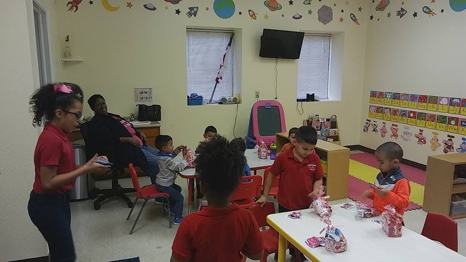 Children and an adult in a classroom