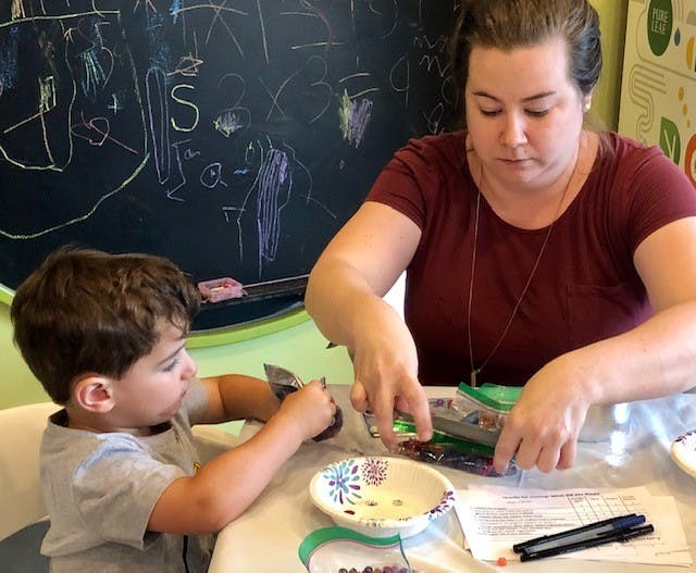 Adult and child doing an activity at a table
