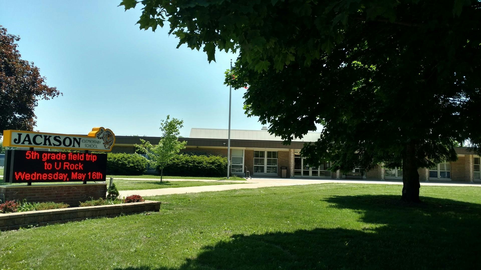Jackson school building with a sign displaying "5th grade field trip to U Rec"