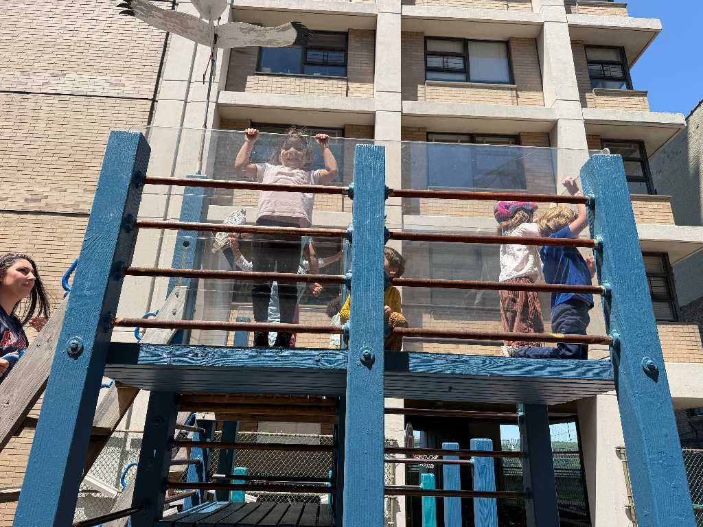 Children playing on an elevated playground structure