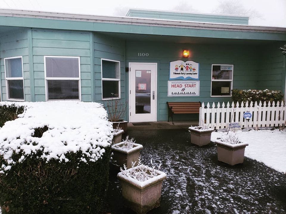 Building entrance with "Head Start" sign, snow on ground and bushes