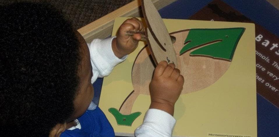 Child playing with a wooden puzzle