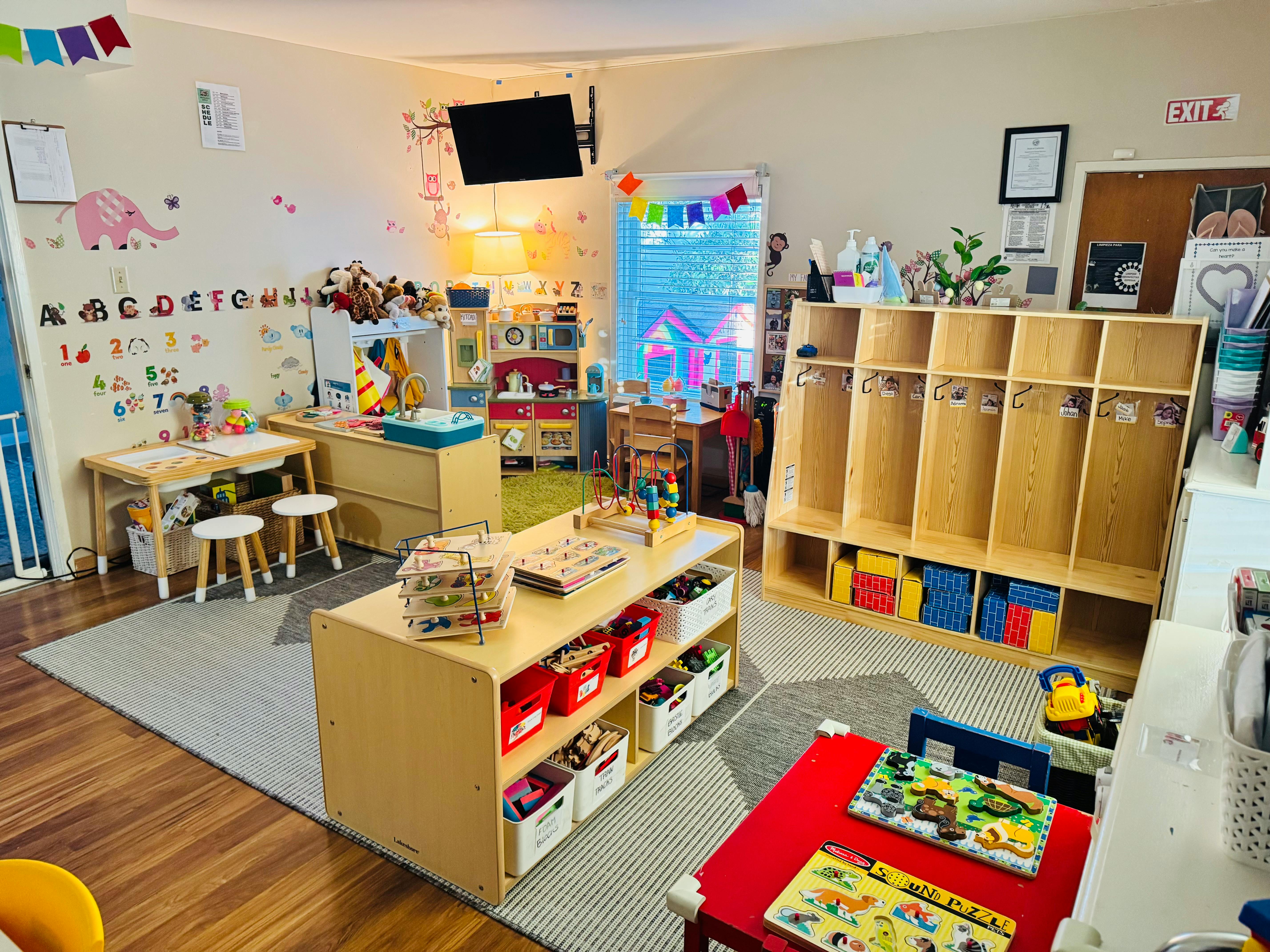 A colorful classroom with small tables, chairs, and storage shelves