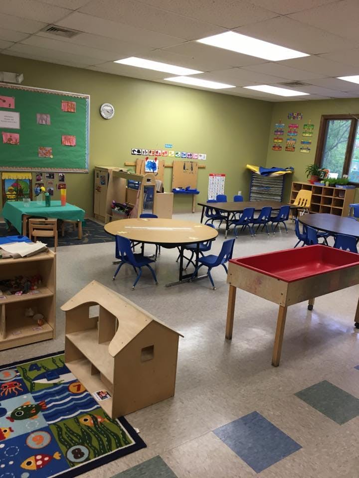 Classroom with tables, chairs, and play furniture