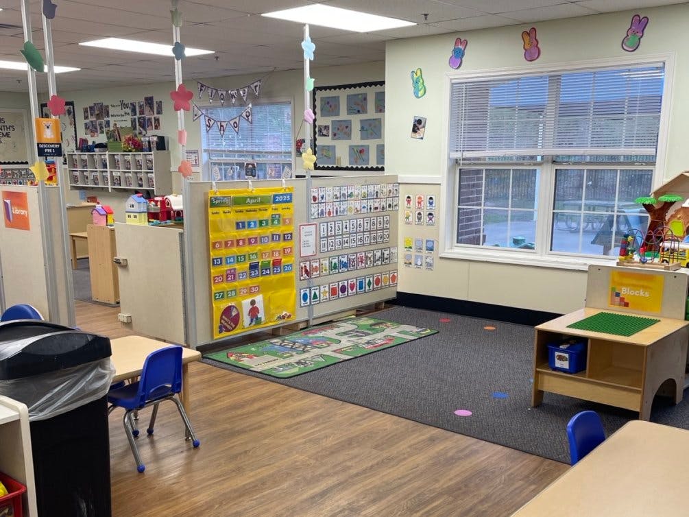 Classroom with a calendar, learning aids, and play areas