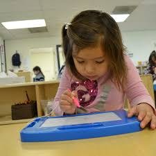 Child drawing on a magnetic sketch pad