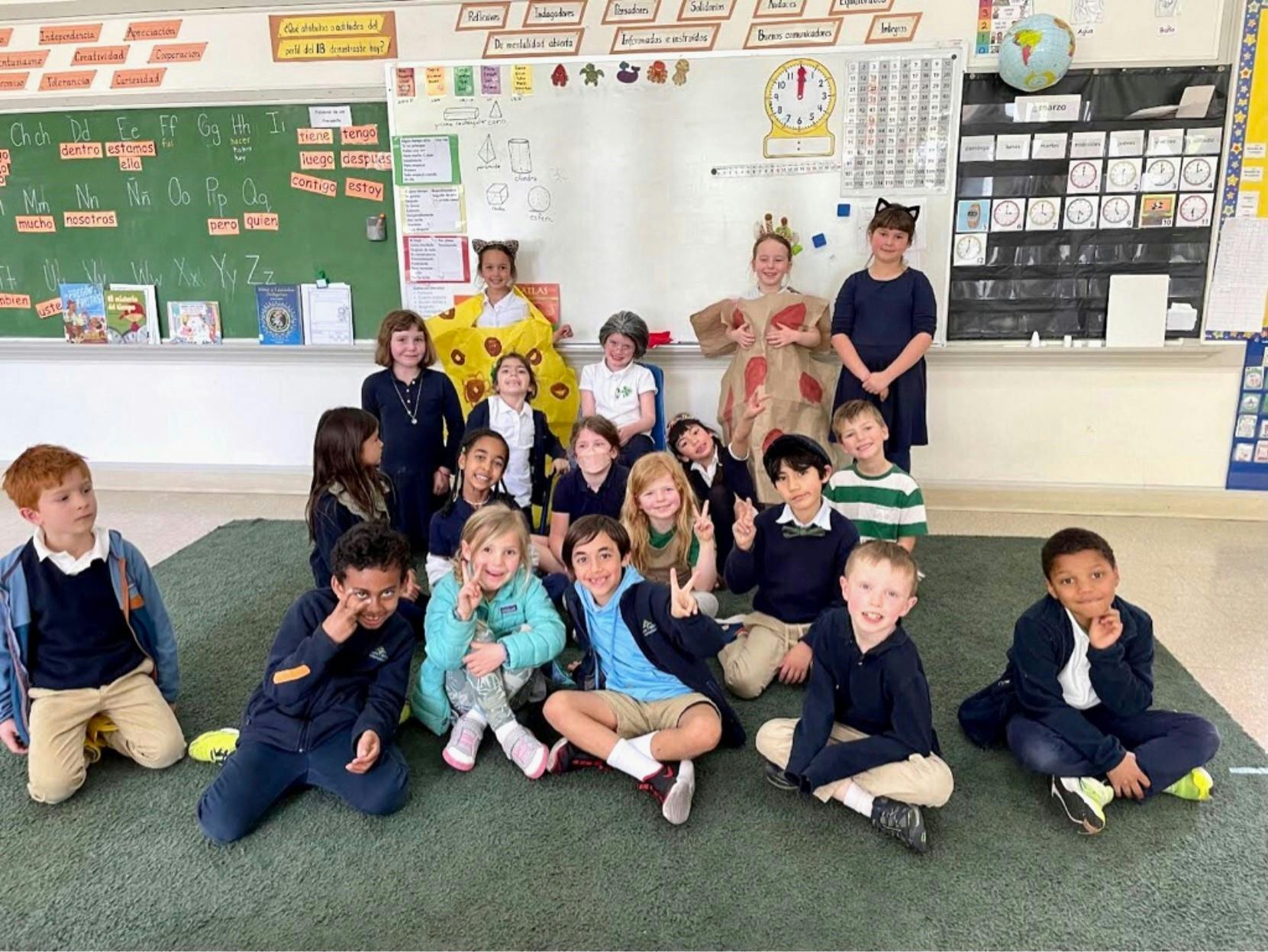 Group of children and teens posing in a classroom