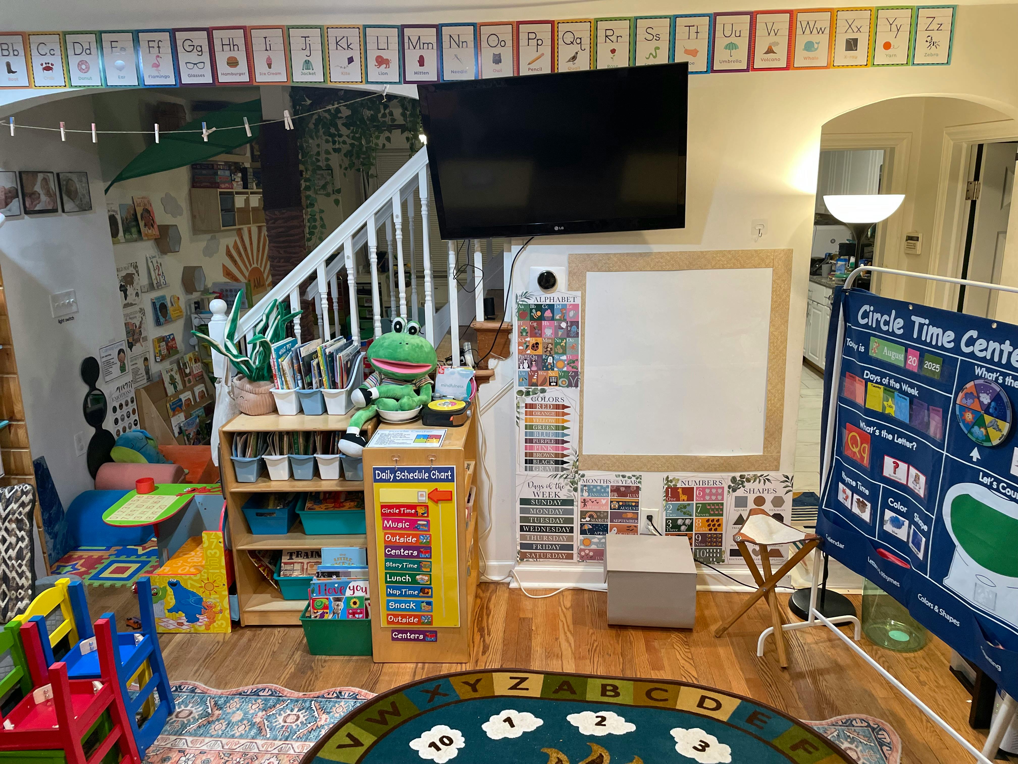 Children's play area with toys, shelves, and a whiteboard