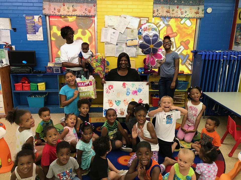 Adults and children in a classroom