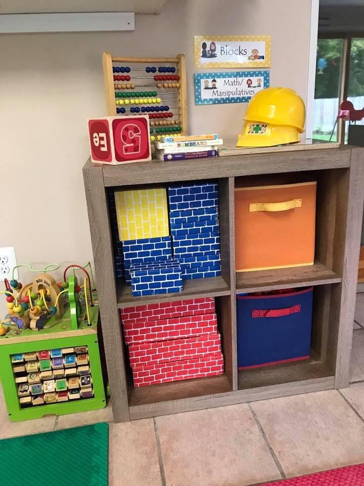 Classroom shelf with abacus, blocks, and storage bins