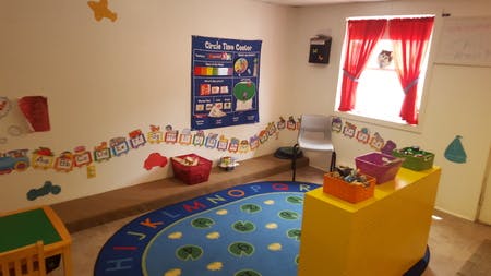 Child's playroom with alphabet rug and colorful decorations