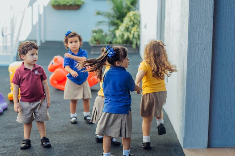 Children in school uniforms playing outdoors