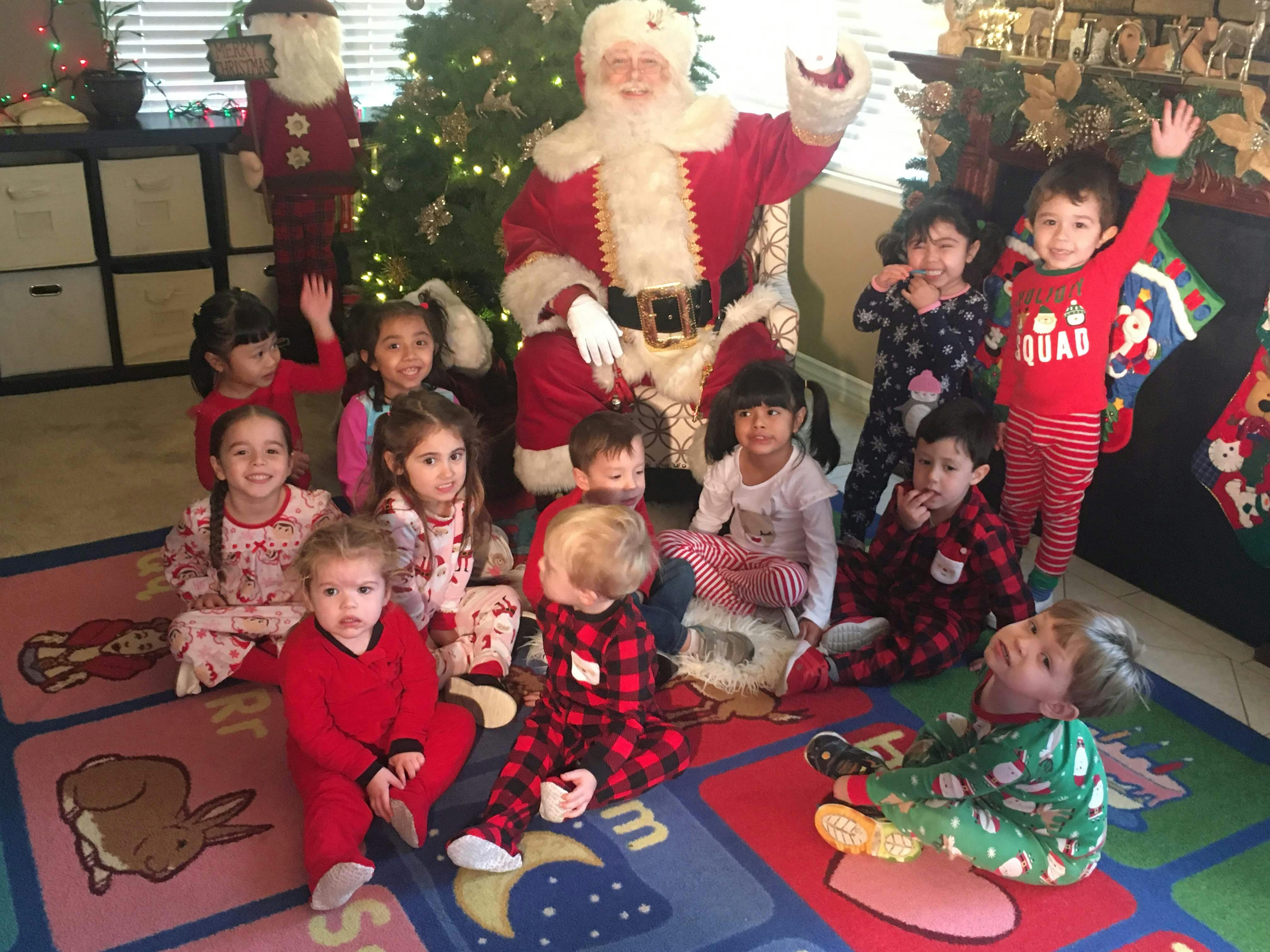 Person dressed as Santa Claus with a group of children