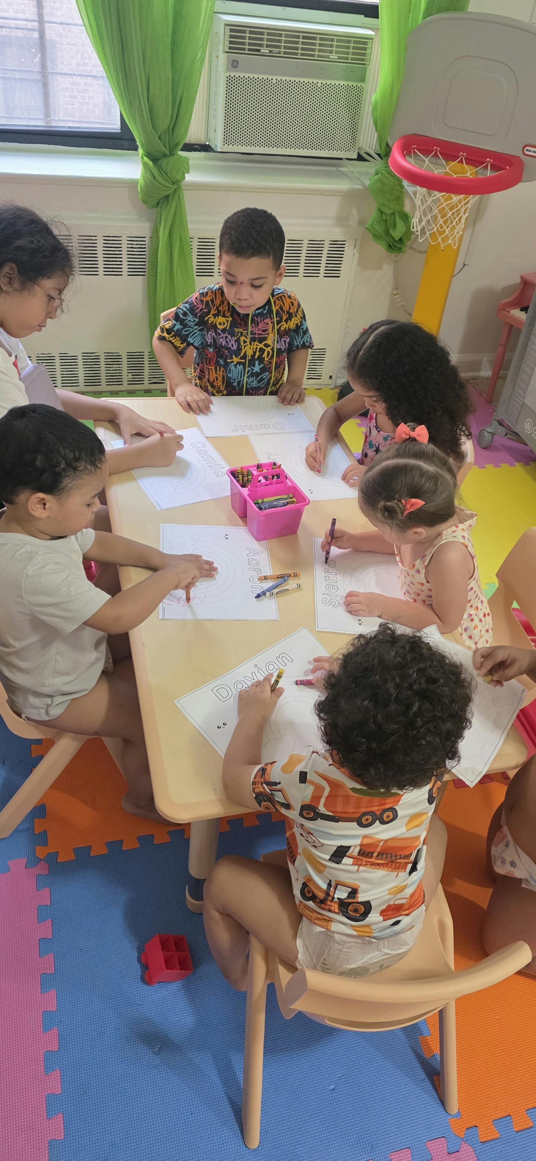 Group of children coloring at a table in a classroom