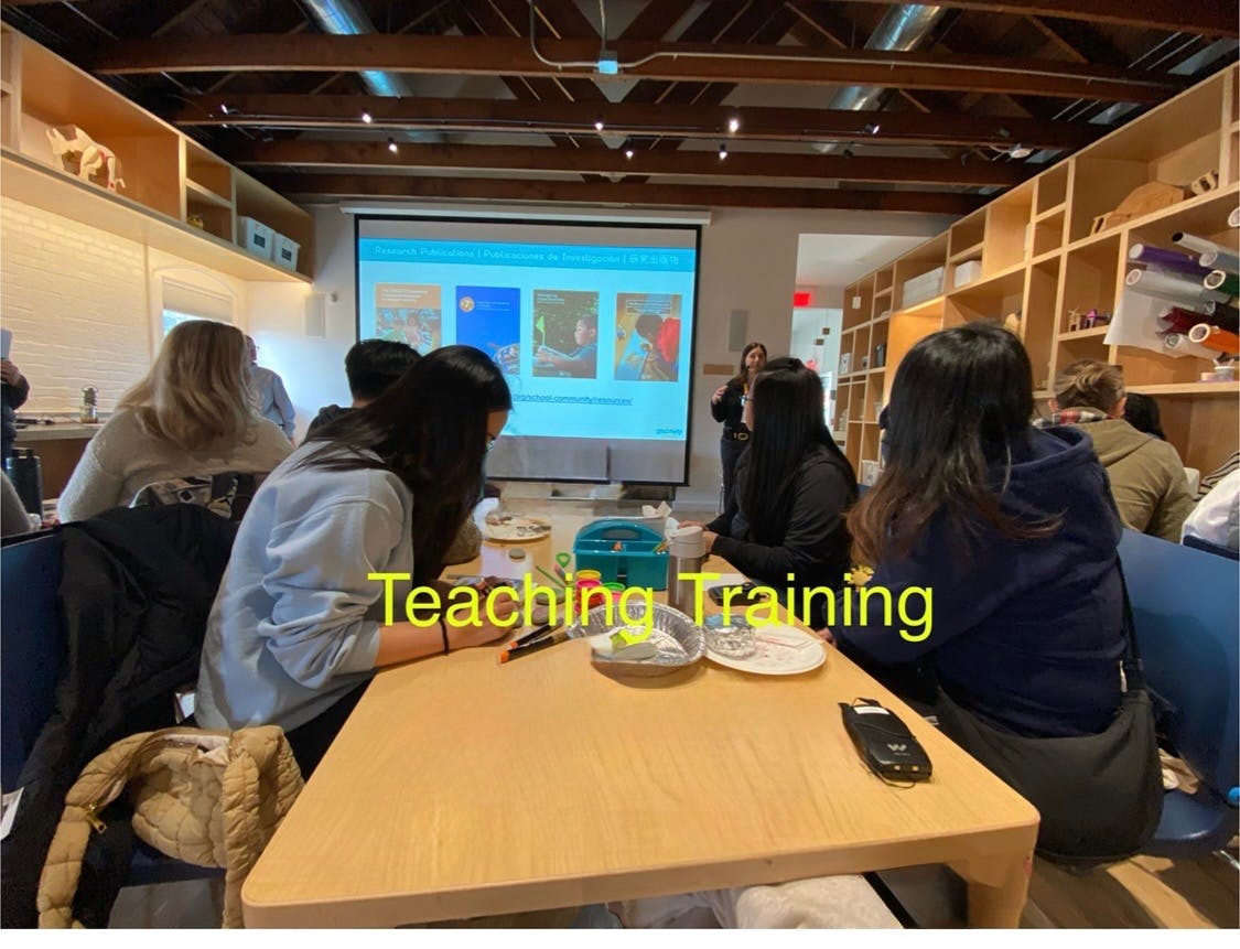 People sitting at tables looking at a projected screen