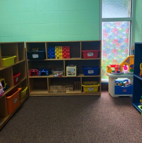 Classroom with shelves of toys and a window
