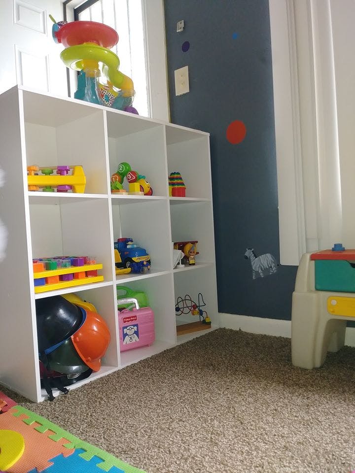 White cubby shelf filled with various toys