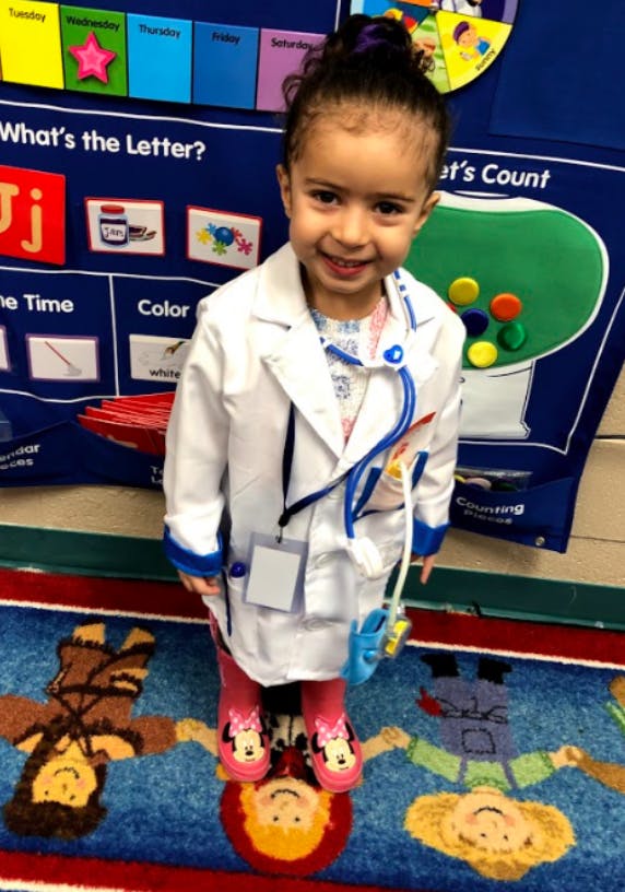 Child in a white lab coat and stethoscope