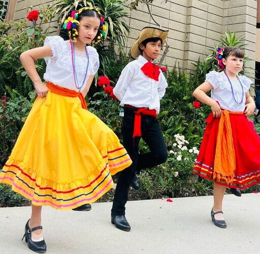 Three children in traditional folk dance costumes