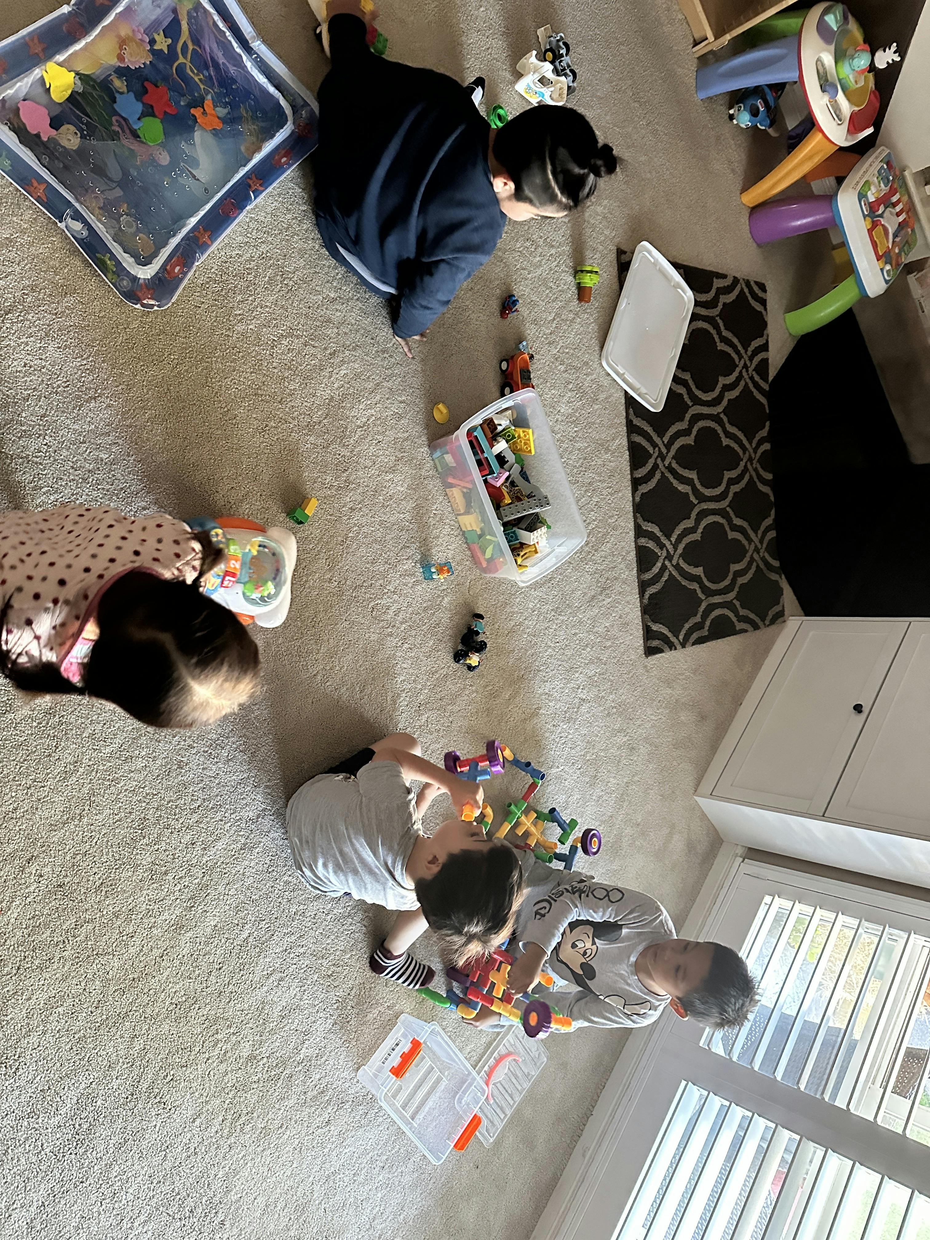 Children playing with toys on a carpeted floor