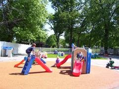 Children playing on a playground structure with slides