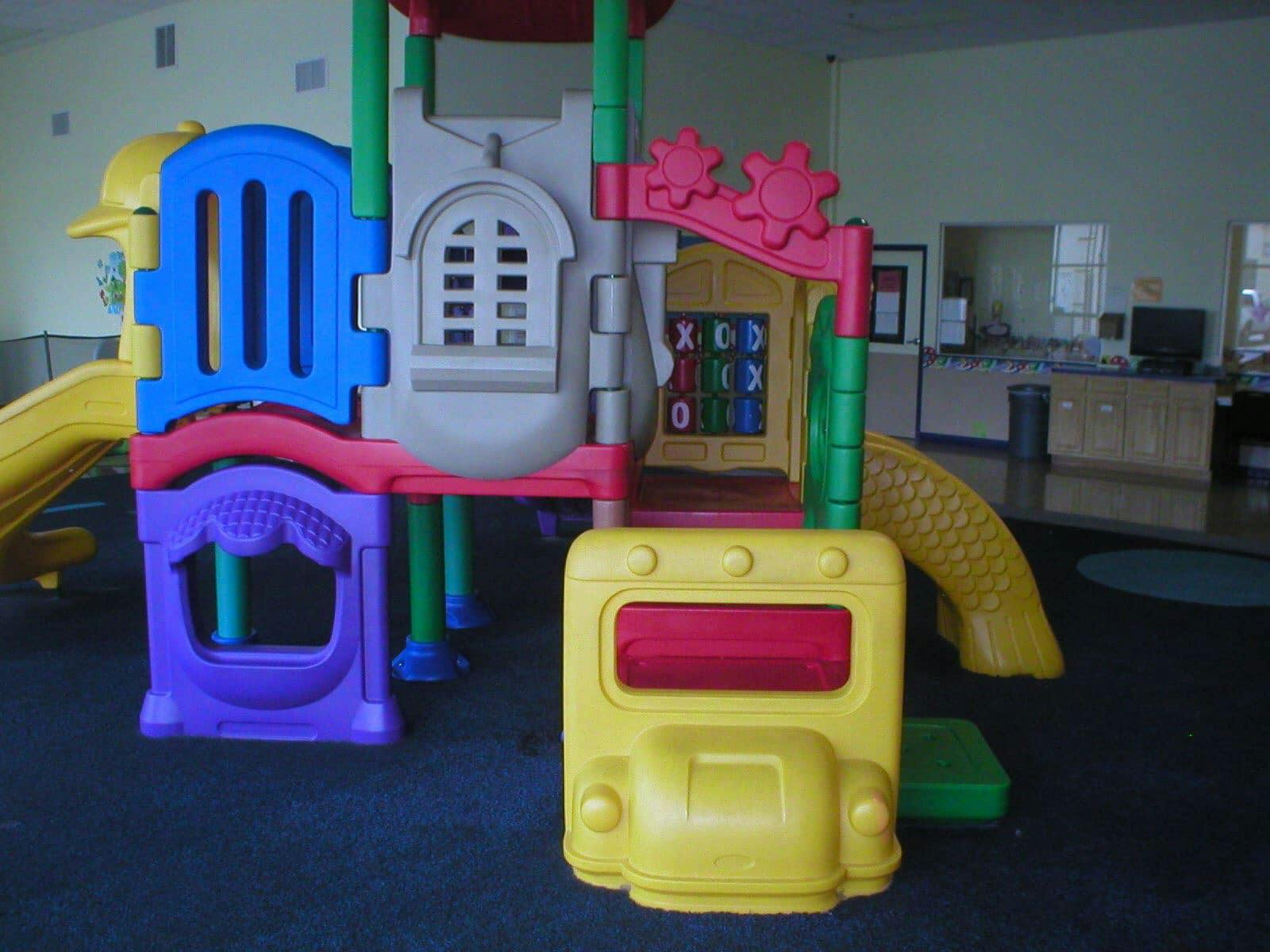 Indoor playground structure with slides and climbing areas