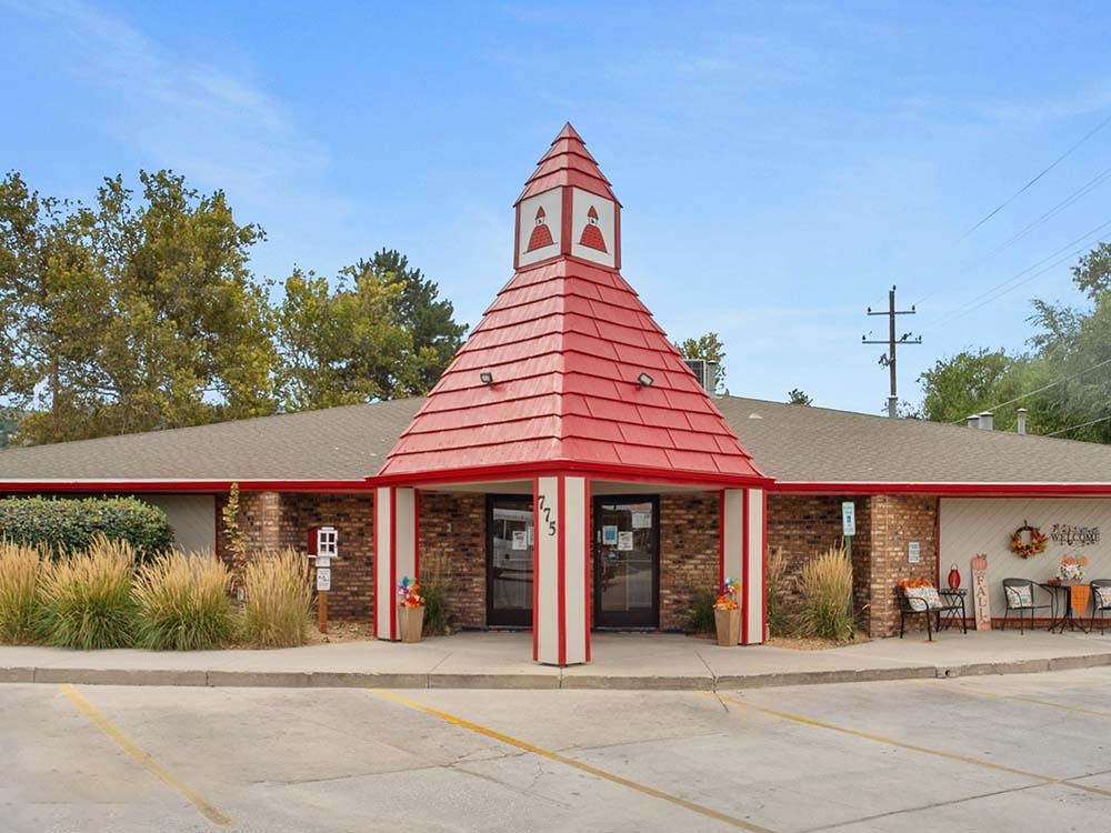 Brick building with a prominent red roof entryway
