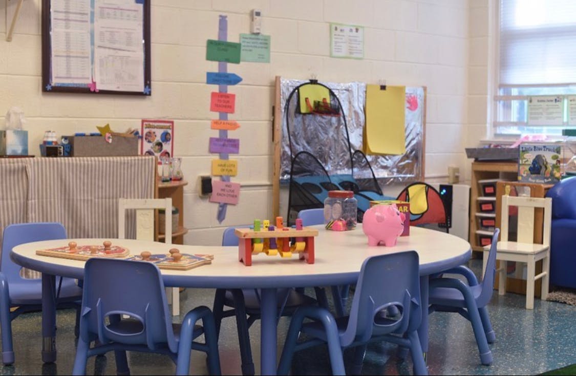 Classroom with a table and chairs, toys on the table
