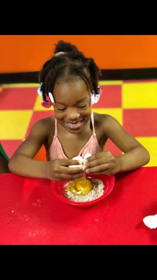 Child cracking an egg into a bowl