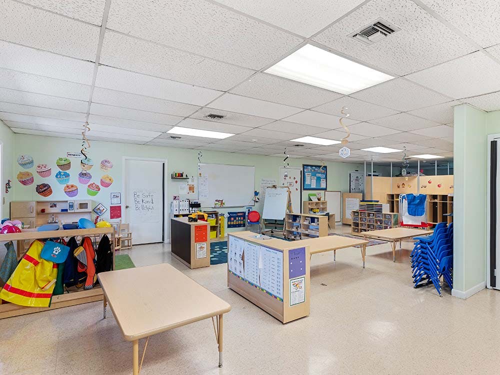 Empty classroom with small tables and chairs