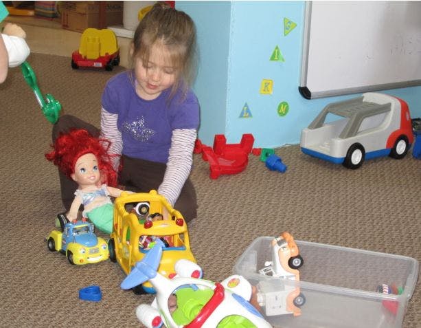 Child playing with toys on the floor