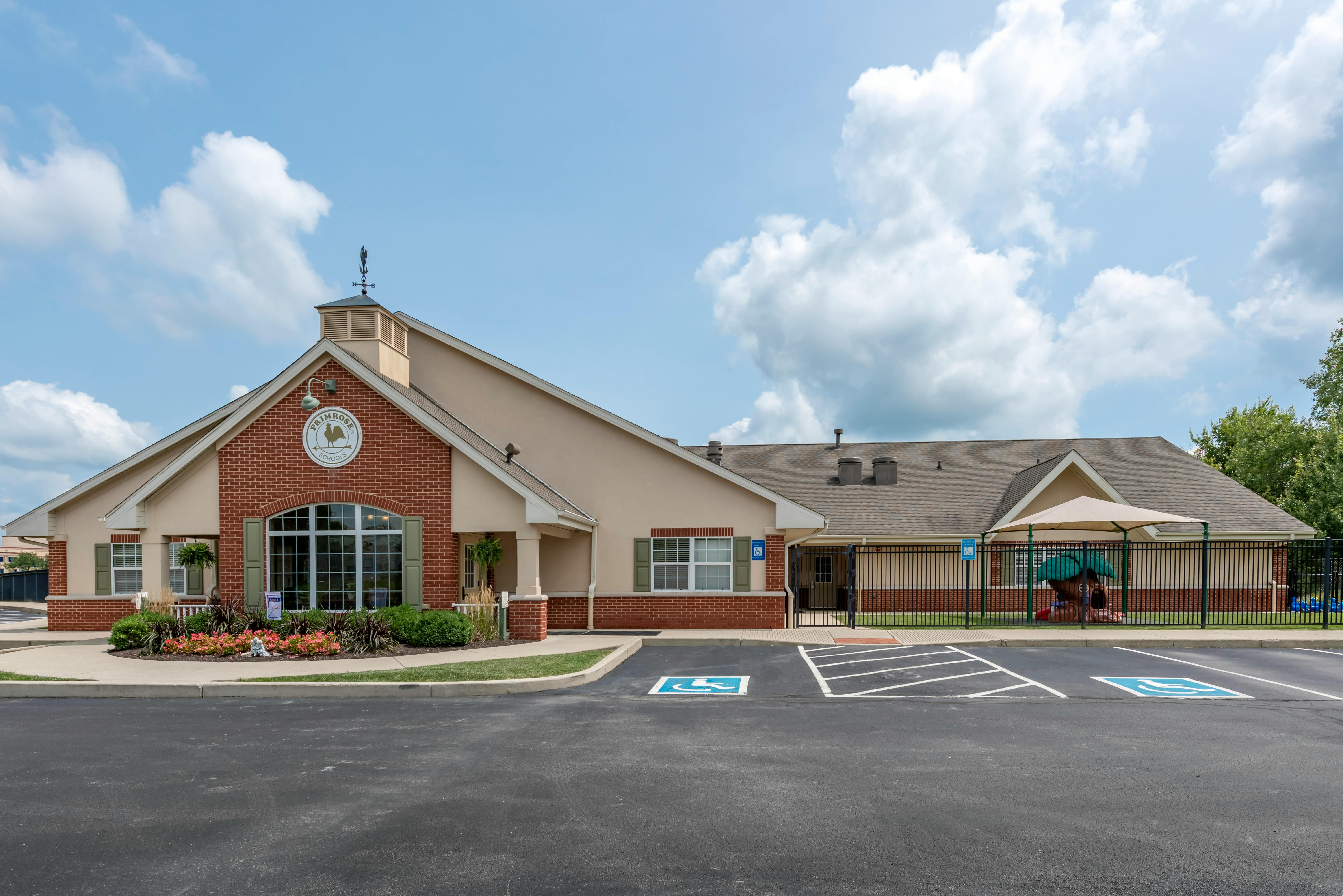 Primrose School building with a playground and accessible parking spots
