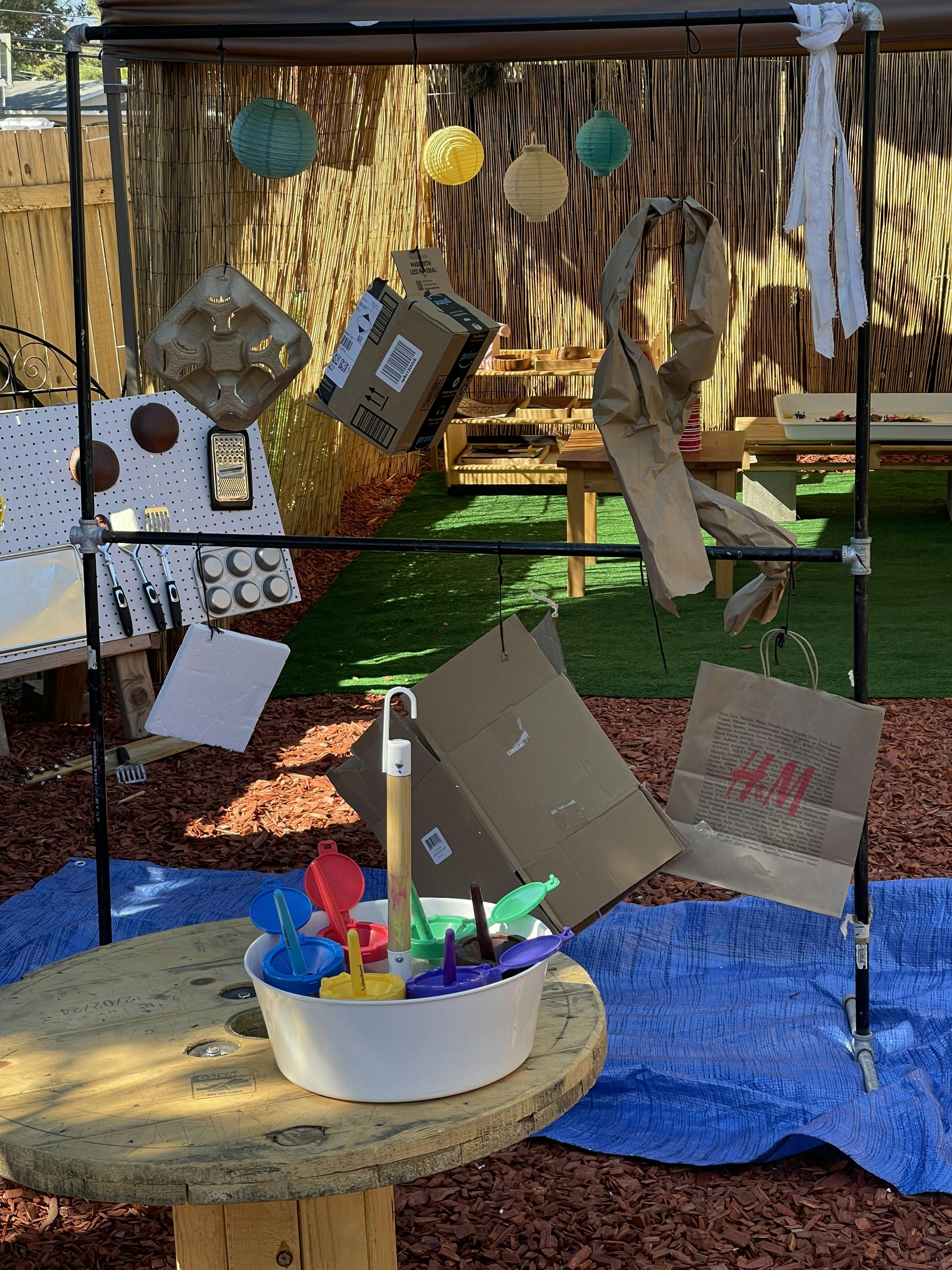 Outdoor play area with various recycled materials and colorful toys