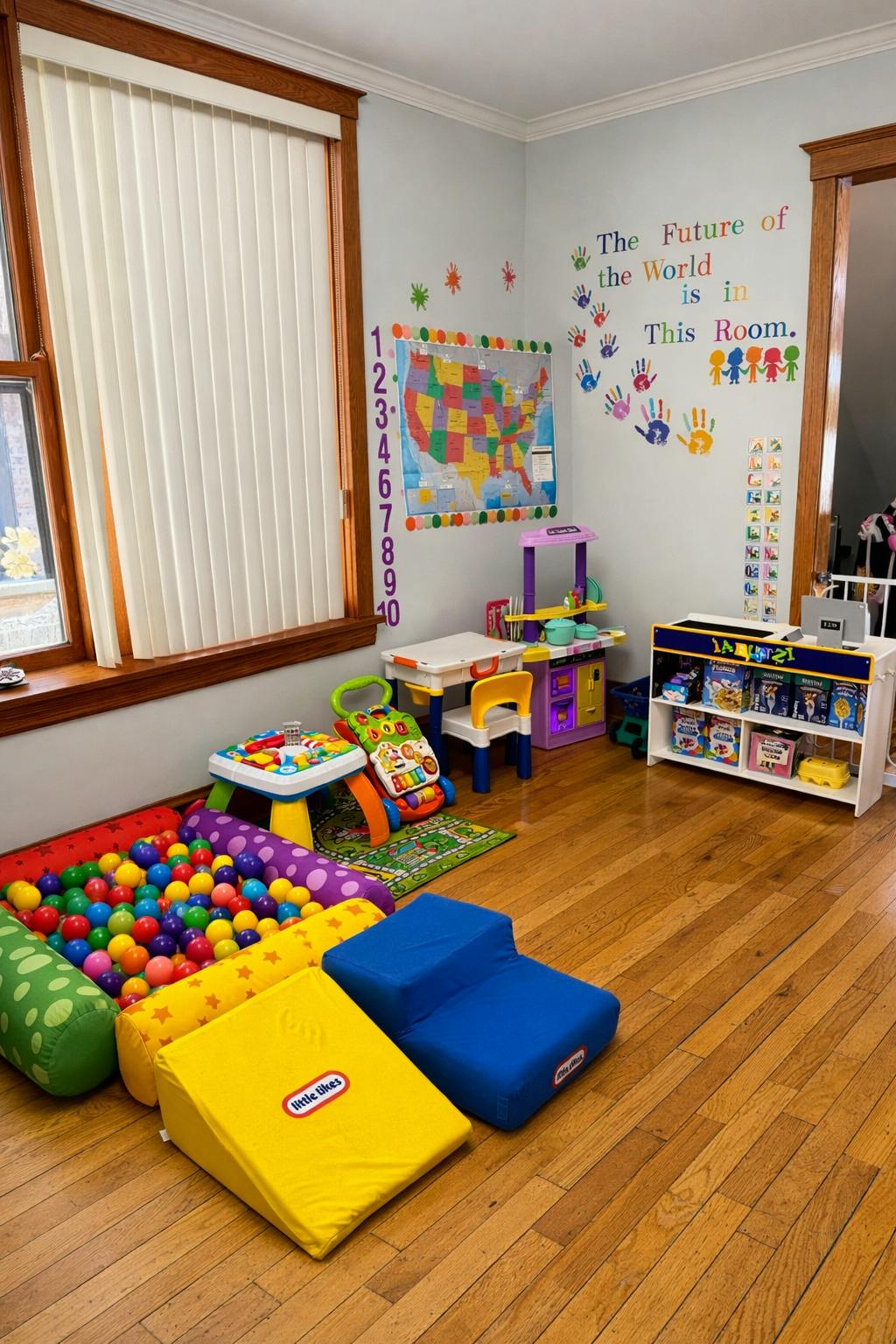 Playroom with a ball pit, soft foam blocks, play kitchen, and educational decor