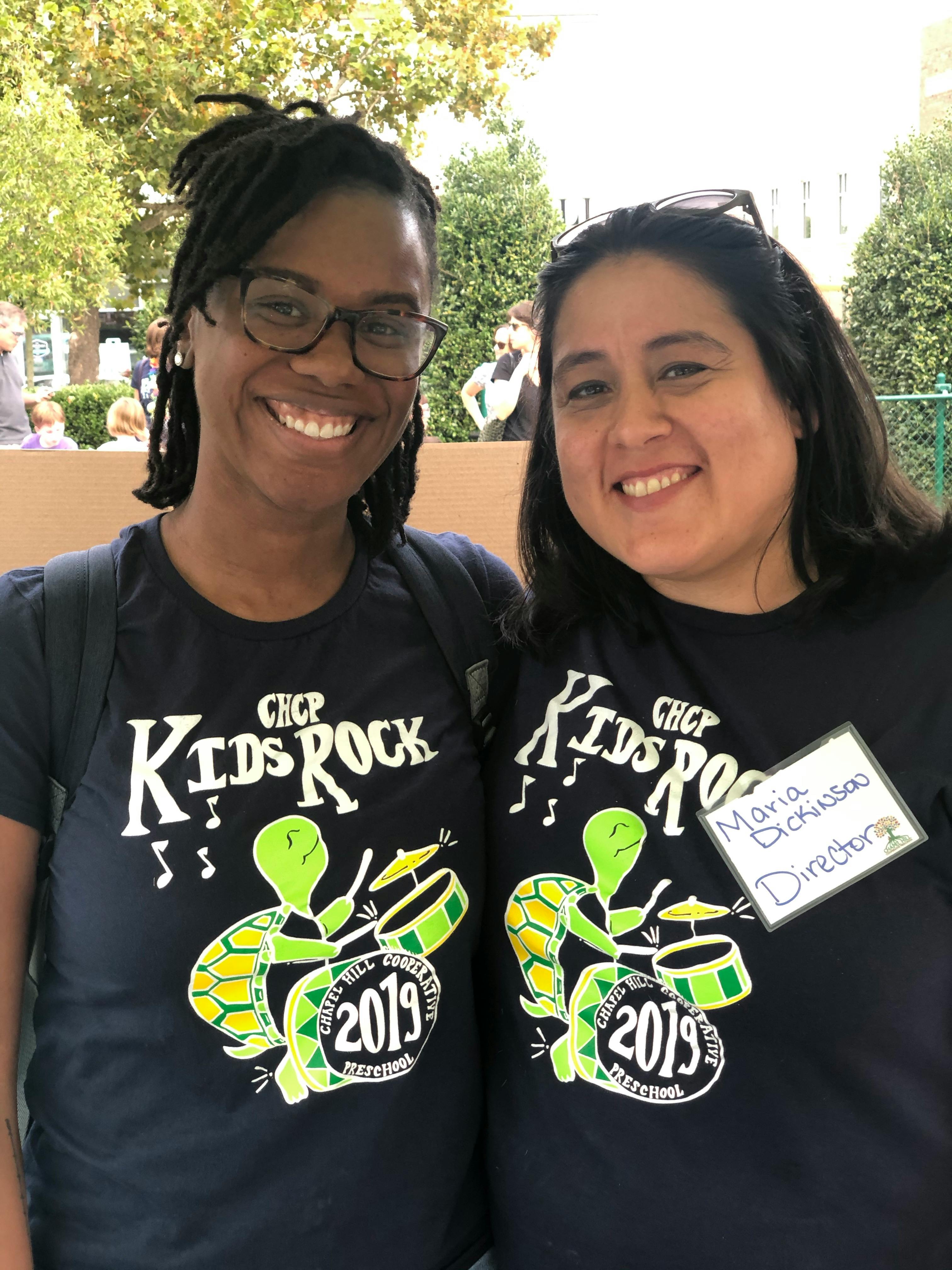 Two people wearing matching "Kids Rock 2019" t-shirts