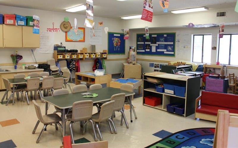Classroom with tables, chairs, learning centers, and decorations