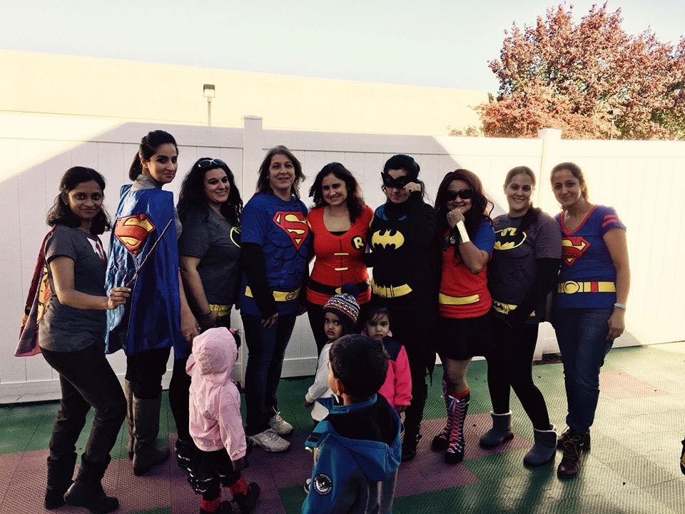 Group of people and children in superhero costumes