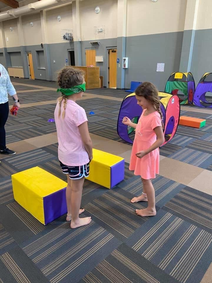 Child with blindfold playing a game with another child