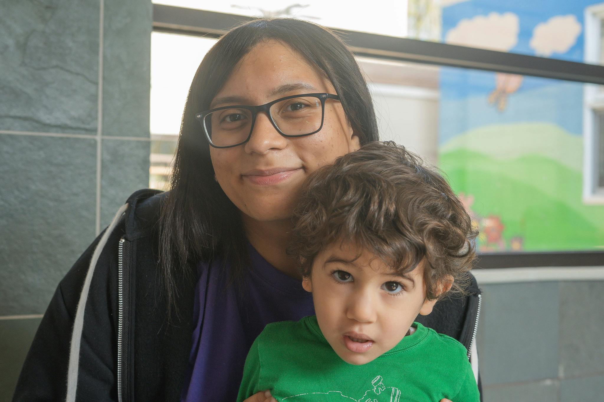 Person in glasses holding a child