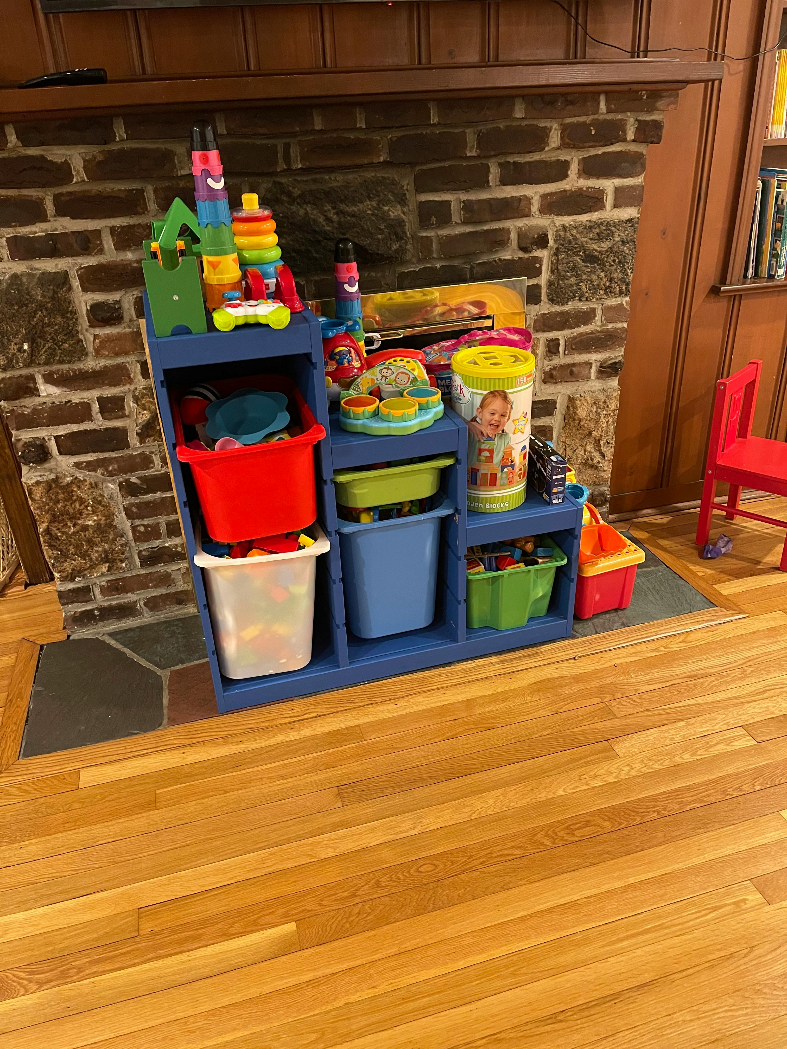 Blue toy organizer with colorful bins and toys