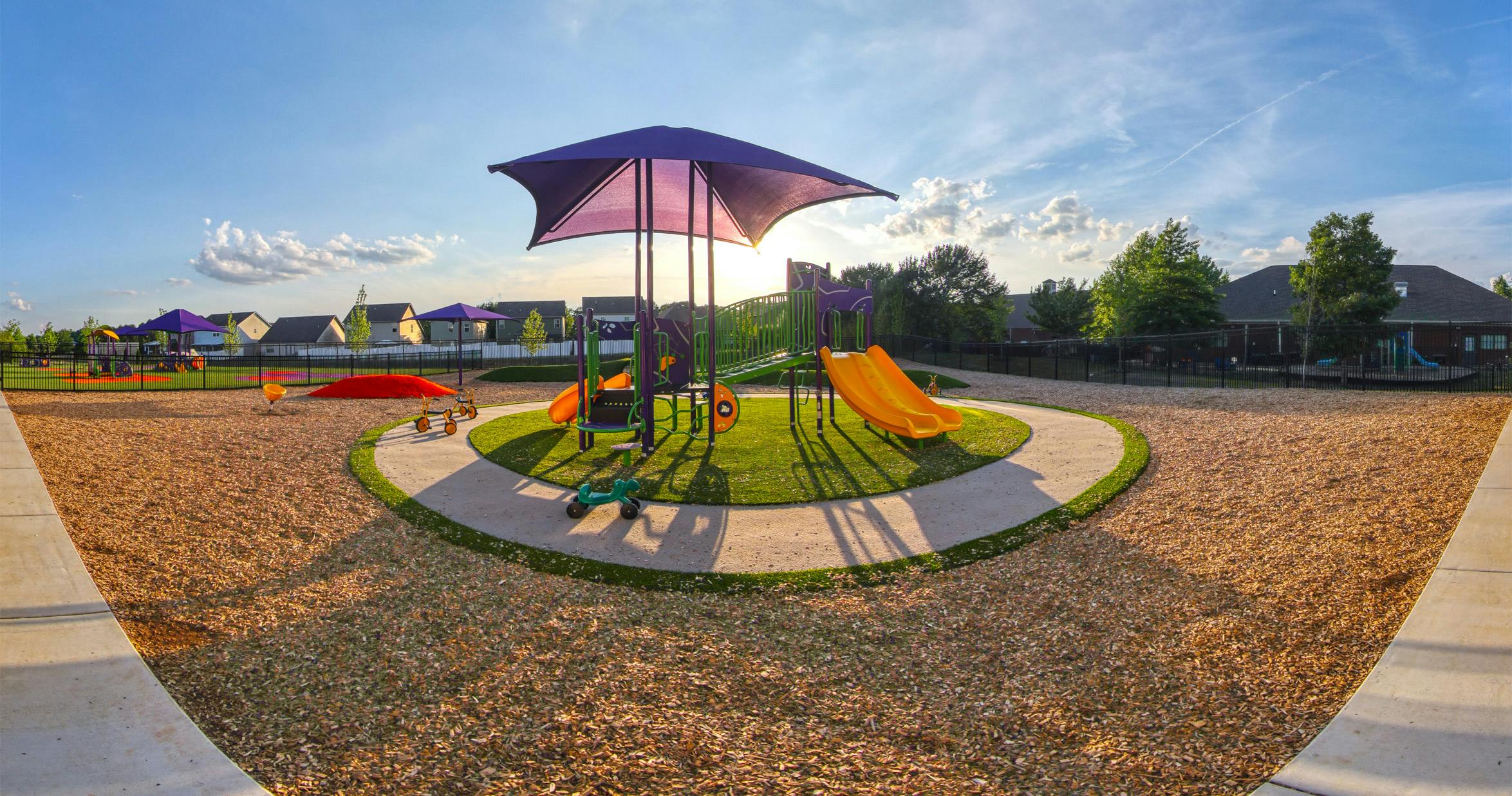 Playground with swings, slides, and climbing structures on a sunny day