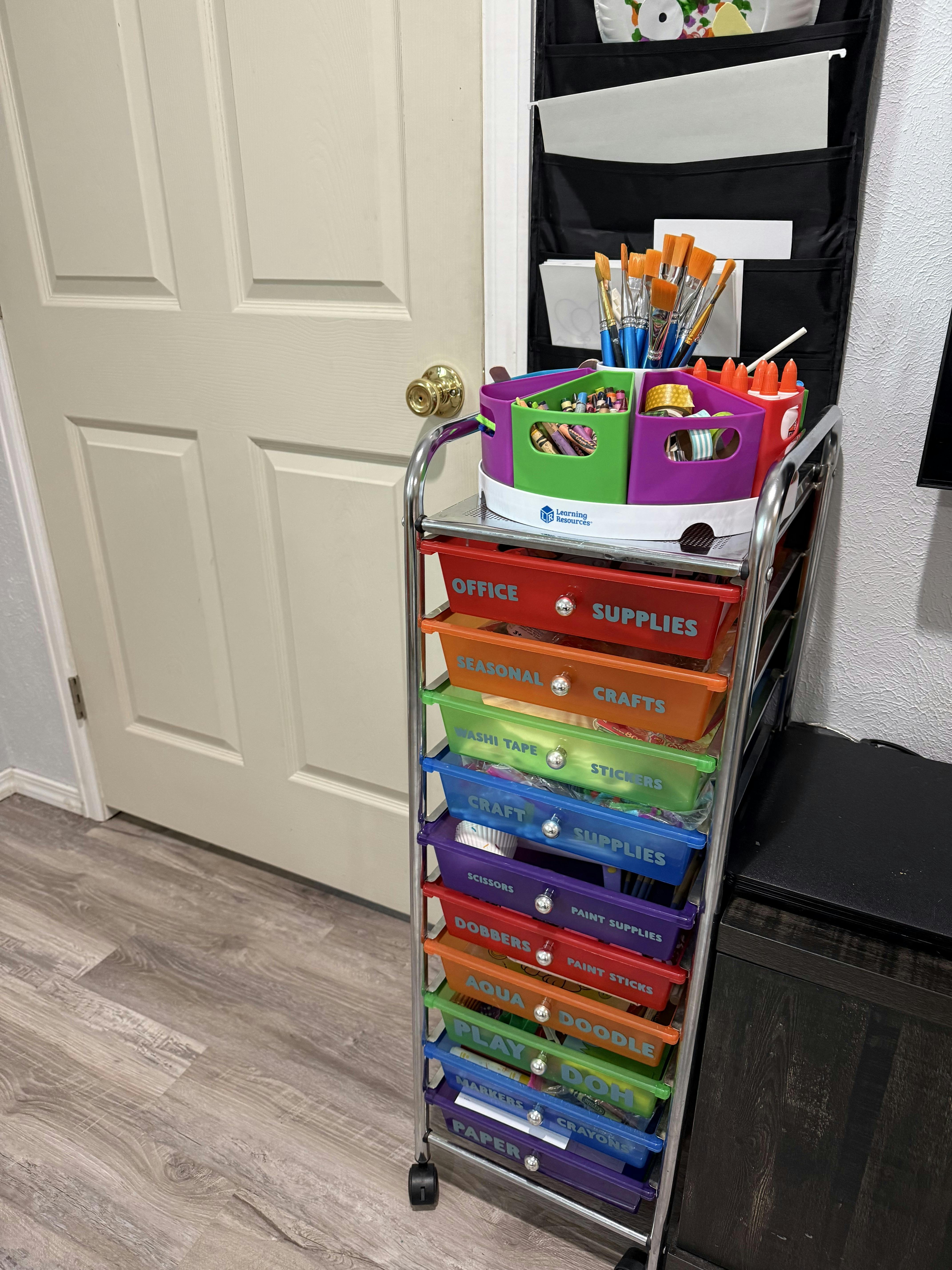 Rainbow rolling cart filled with various craft and office supplies