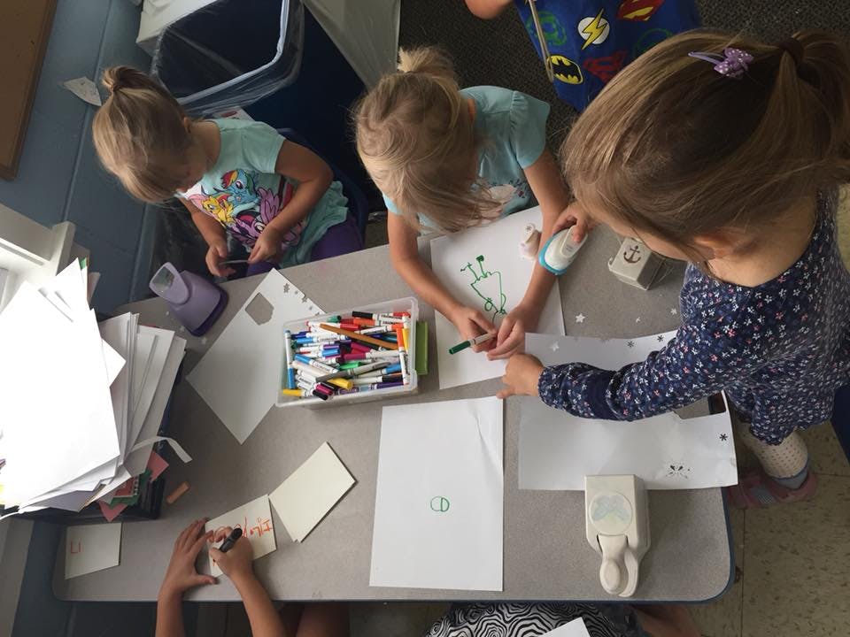 Children drawing and coloring at a table