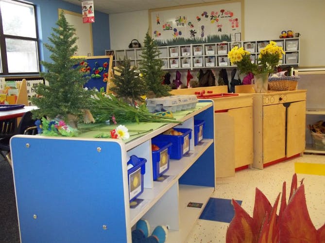 Classroom with trees and a play kitchen