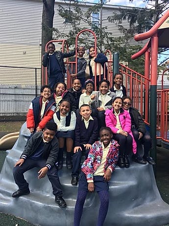 Group of children posing on playground equipment
