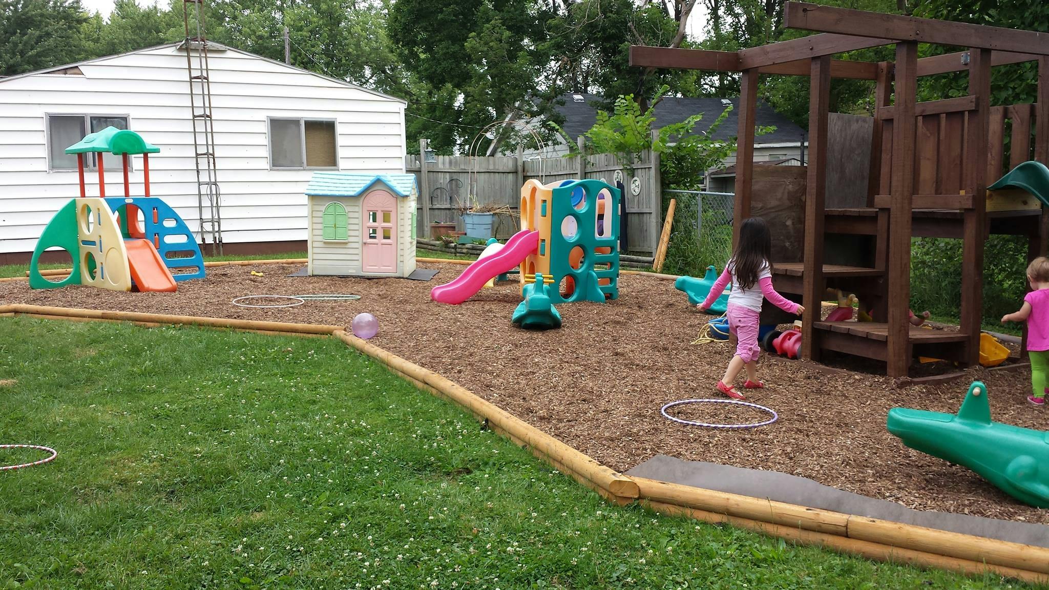 Children playing on a playground with slides and play structures