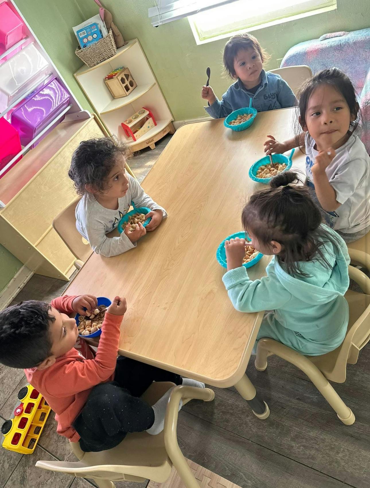 Children eating cereal at a table