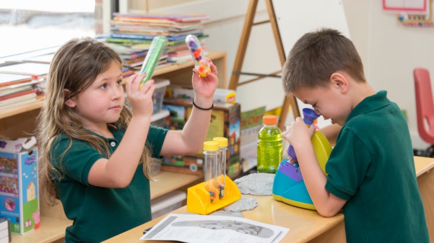 Two children playing with toys at a table
