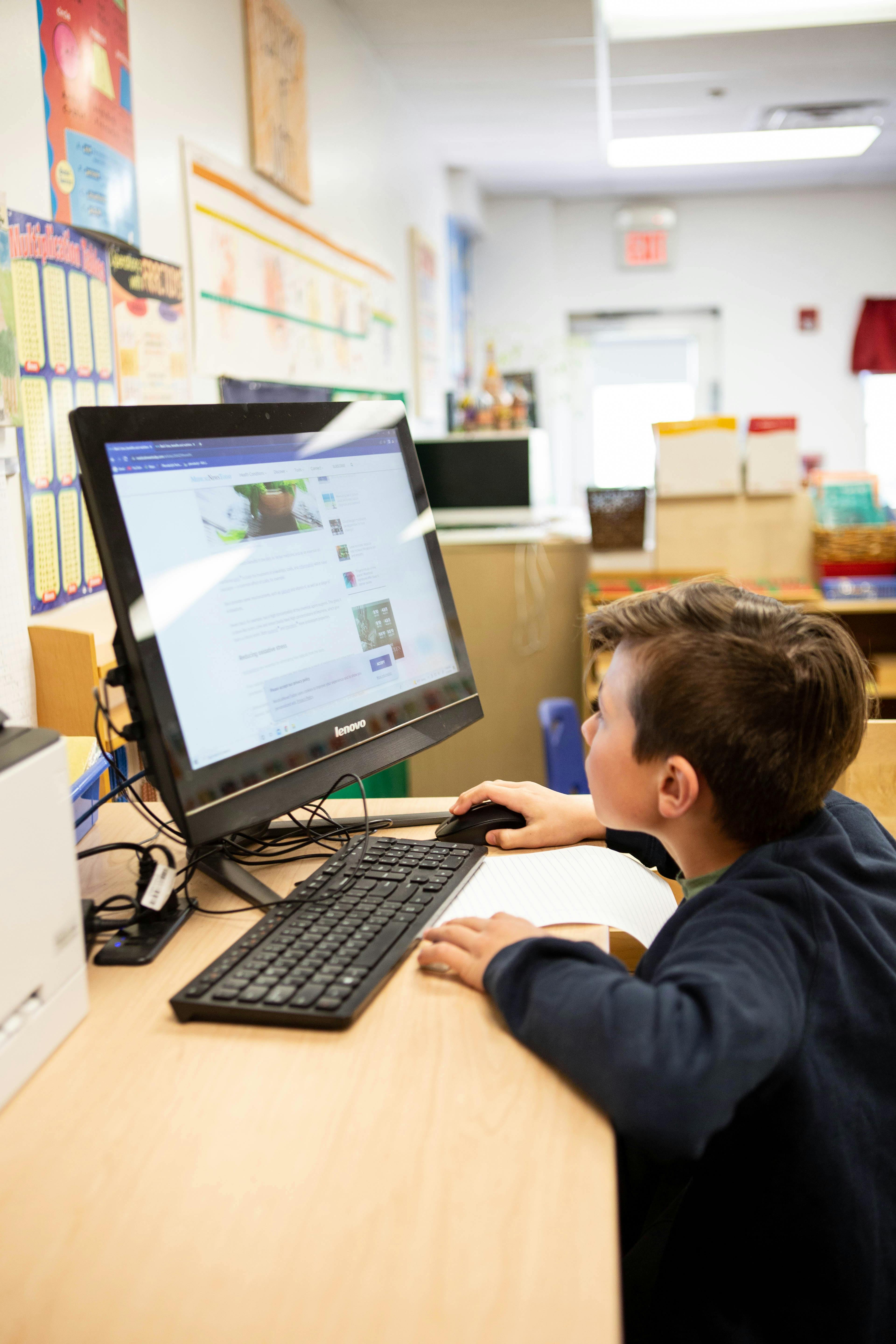 Child using a computer in a classroom